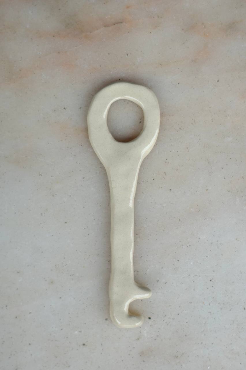 Ceramic bottle opener shaped like a key