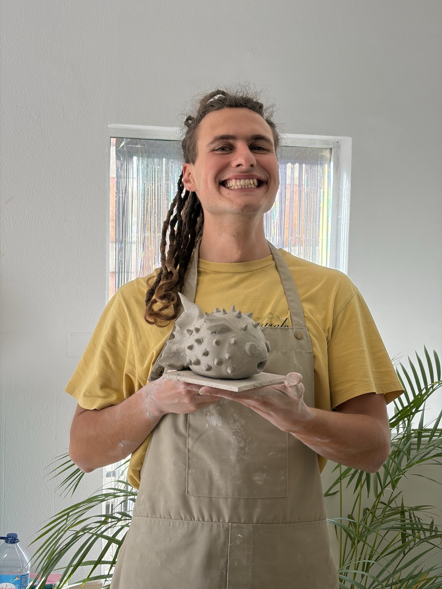 A spiky clay pufferfish held up at Clayplay